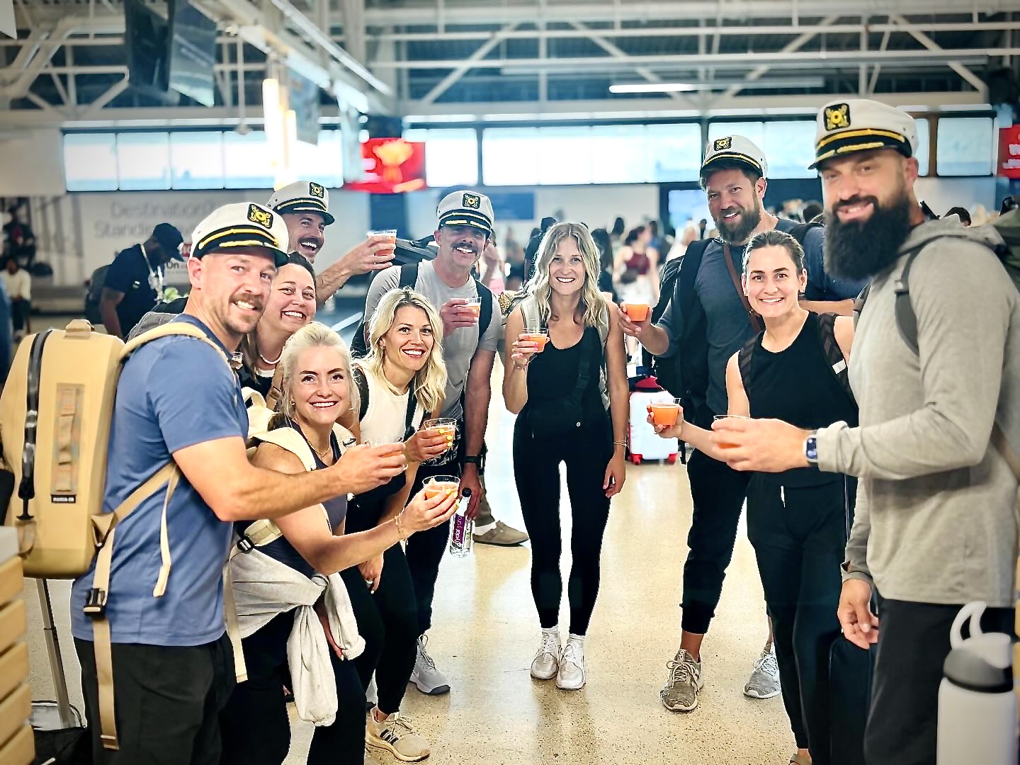 Guests cheer at the airport with local rum.